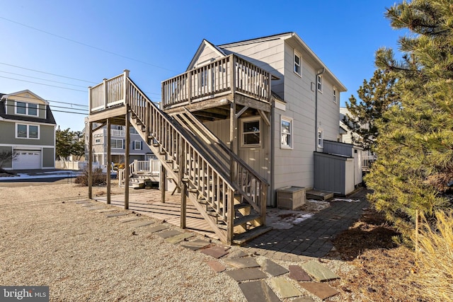 rear view of property with a wooden deck