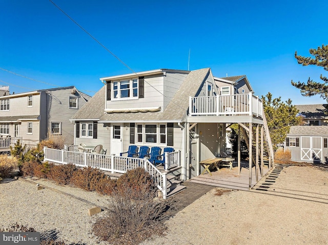 rear view of property with a wooden deck