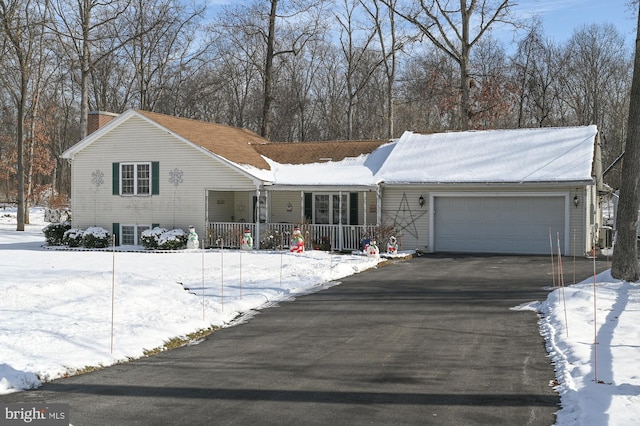 single story home with a garage and covered porch