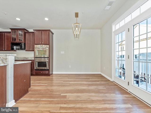 kitchen featuring light hardwood / wood-style floors, pendant lighting, and double oven