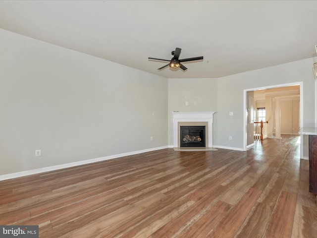 unfurnished living room with ceiling fan and light hardwood / wood-style flooring