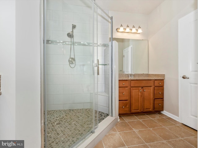 bathroom featuring an enclosed shower, vanity, and tile patterned flooring