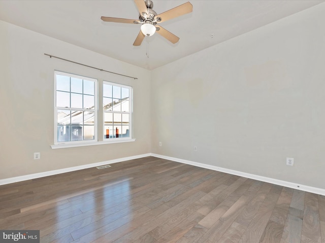 spare room with wood-type flooring and ceiling fan