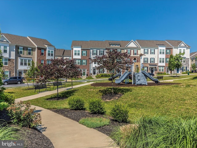 view of community with a lawn and a playground