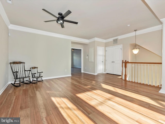 interior space with hardwood / wood-style flooring, ceiling fan, and ornamental molding