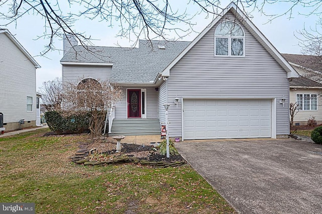 view of front of property with a garage and a front lawn