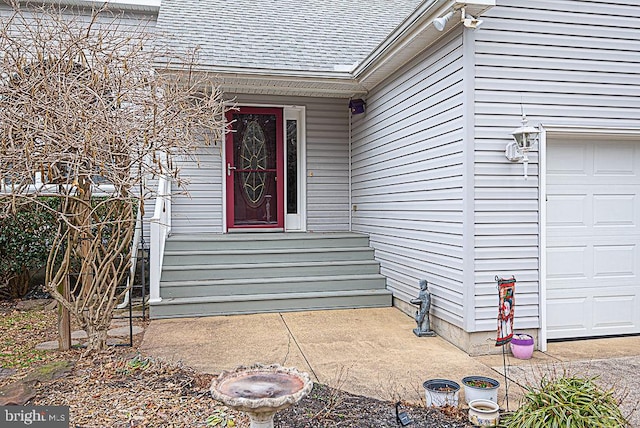 doorway to property with a garage