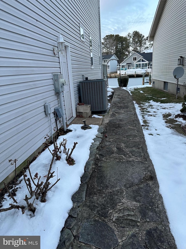 view of snowy exterior featuring cooling unit