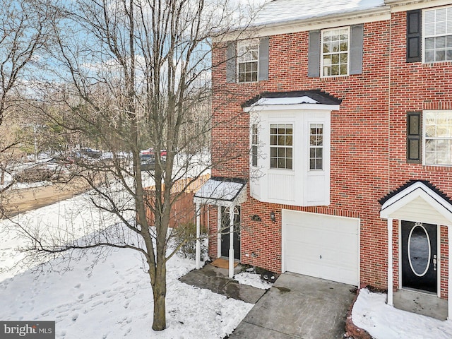 townhome / multi-family property featuring a garage