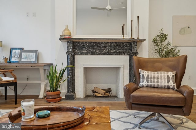 sitting room featuring ceiling fan and light wood-type flooring