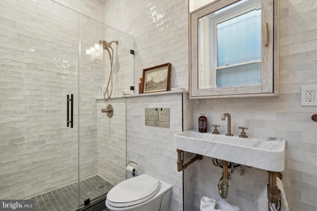 bathroom with toilet, an enclosed shower, and sink