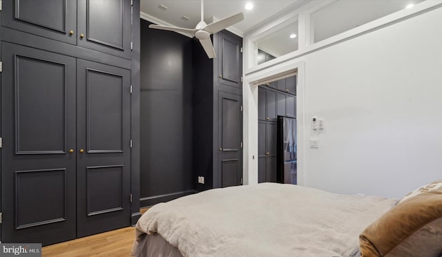 bedroom with ceiling fan, light hardwood / wood-style floors, and crown molding