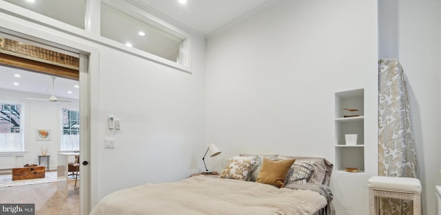 bedroom featuring light hardwood / wood-style floors and crown molding