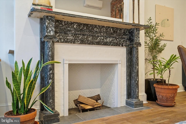 interior details with a wall unit AC and wood-type flooring