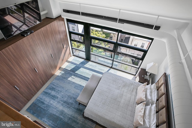 living room with wooden walls and a wall of windows