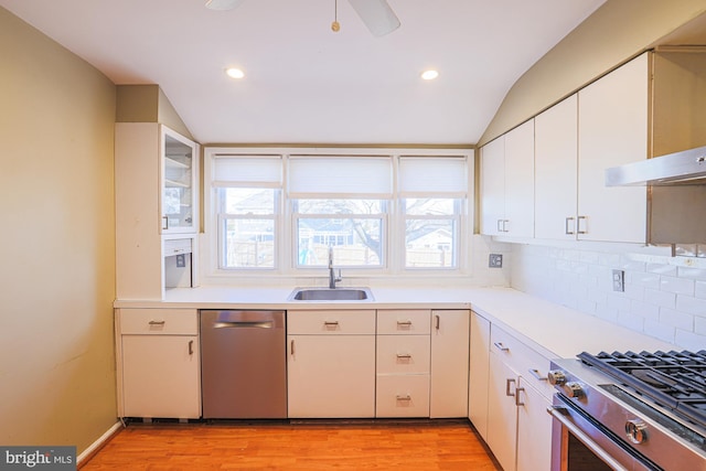 kitchen with white cabinetry, stainless steel appliances, and sink