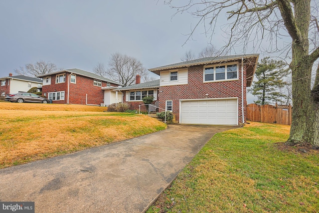 split level home featuring a garage and a front lawn