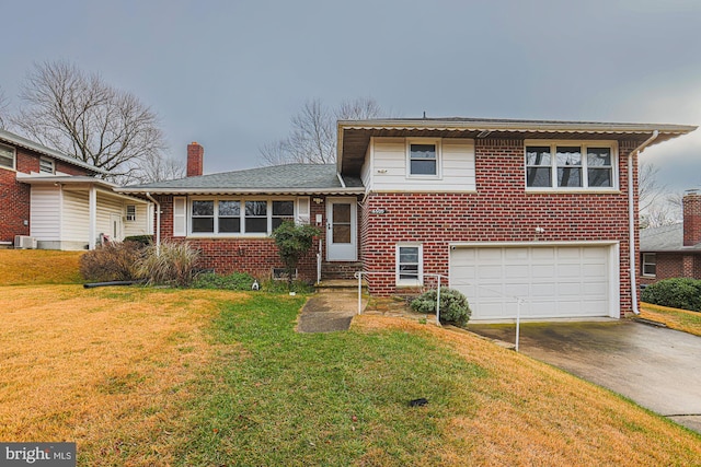 split level home featuring a garage, central AC unit, and a front lawn