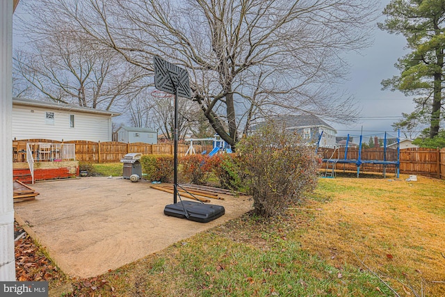 view of yard with a playground, a trampoline, and a patio area