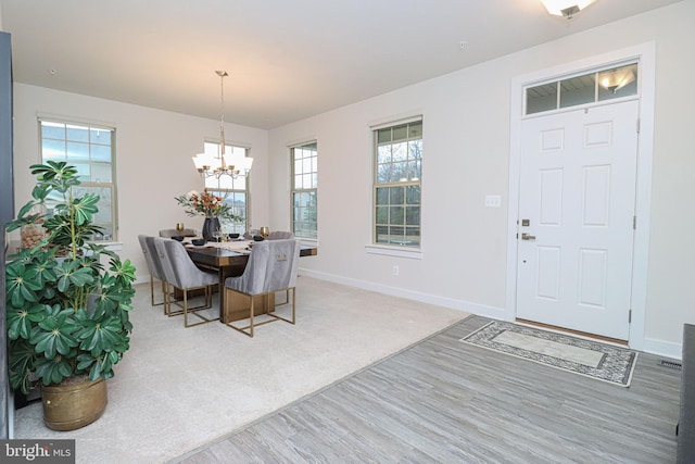 dining room with hardwood / wood-style flooring and a chandelier