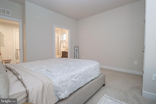 carpeted bedroom with connected bathroom