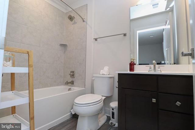 full bathroom featuring vanity, toilet, tiled shower / bath combo, and hardwood / wood-style floors