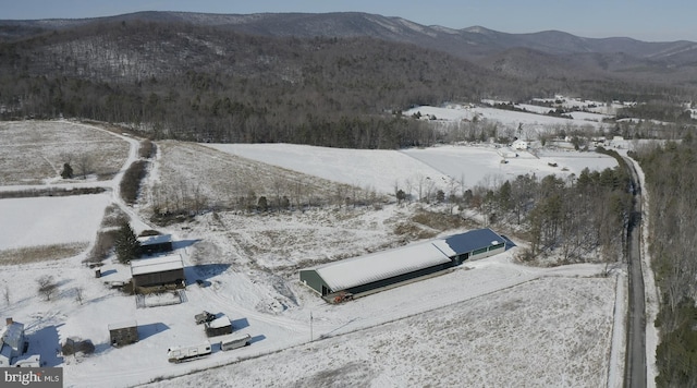 snowy aerial view with a mountain view