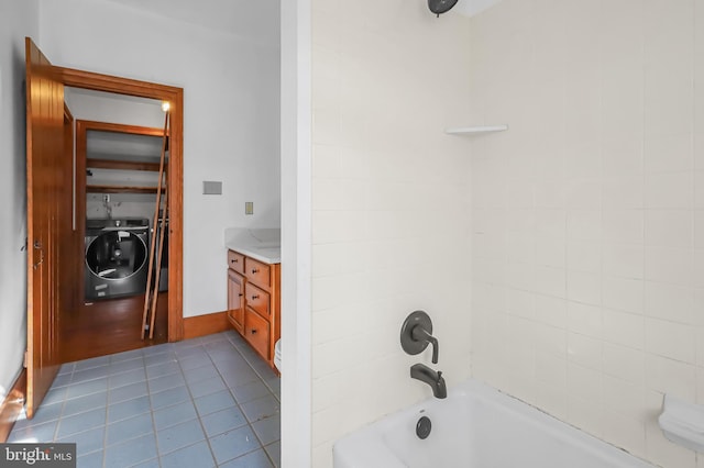 full bathroom featuring washer / dryer, tile patterned flooring, shower / washtub combination, and vanity