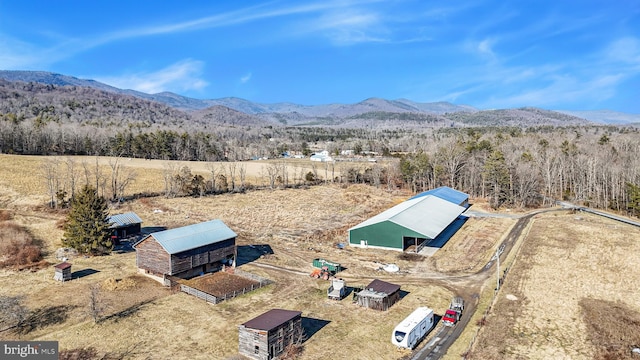 aerial view with a mountain view and a wooded view