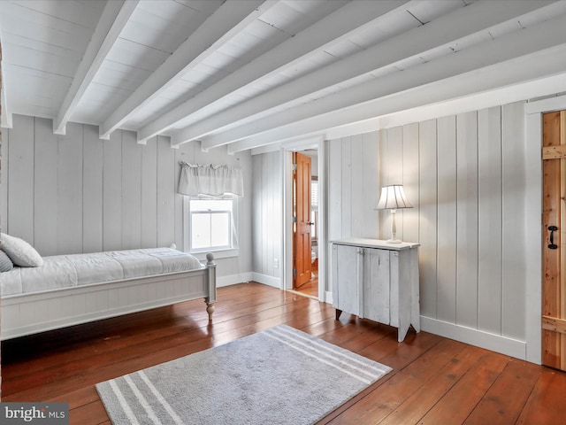 bedroom featuring wood-type flooring, beamed ceiling, and baseboards