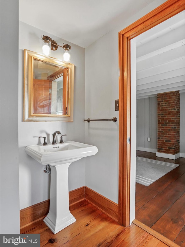 bathroom featuring hardwood / wood-style flooring and baseboards