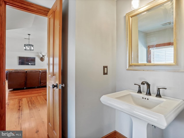 bathroom featuring visible vents, a sink, and wood finished floors