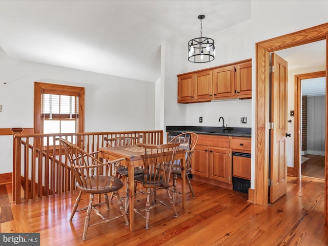 dining room with a chandelier and light wood-type flooring