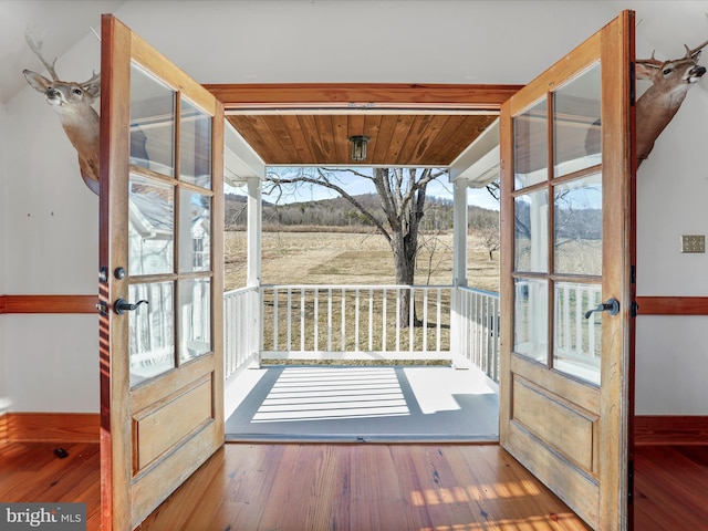 doorway with hardwood / wood-style flooring