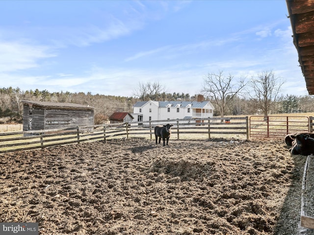 view of yard with a rural view and an enclosed area