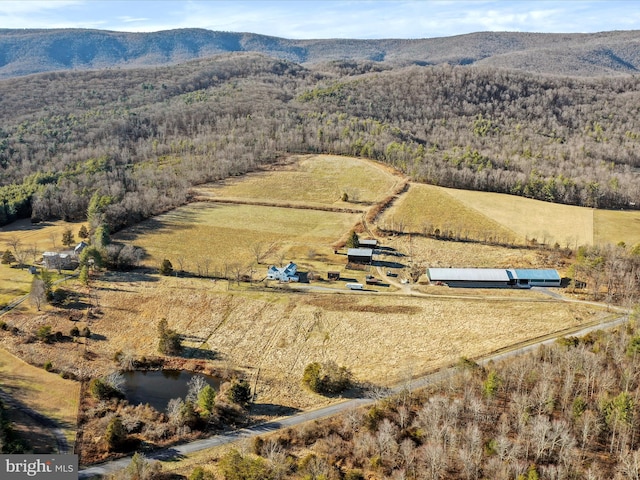 bird's eye view featuring a rural view, a mountain view, and a view of trees