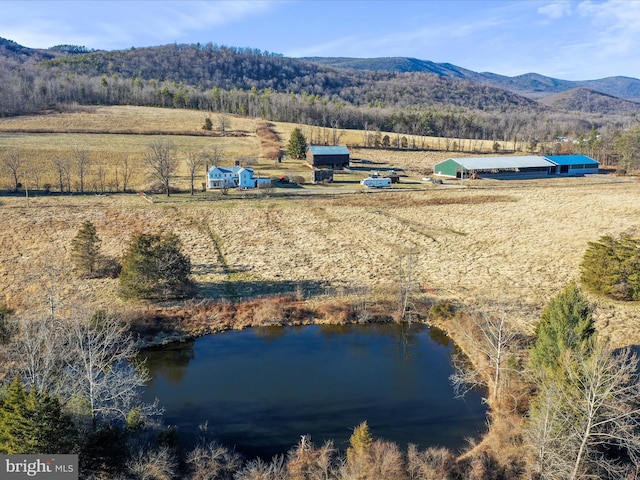 aerial view featuring a rural view, a wooded view, and a water and mountain view