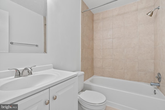 full bathroom with toilet, vanity, and tiled shower / bath