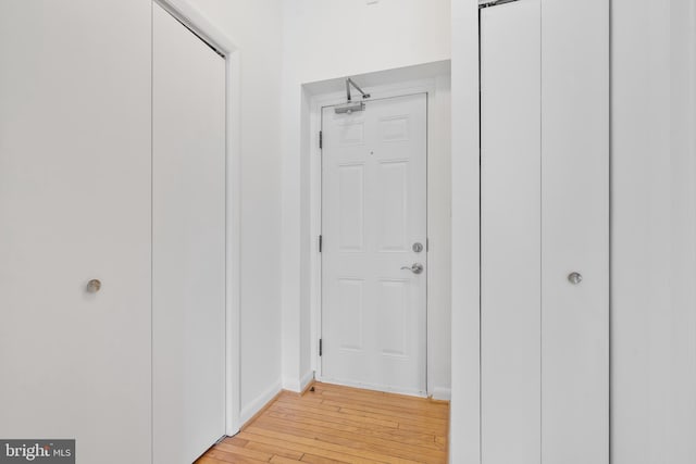 hallway with light hardwood / wood-style floors