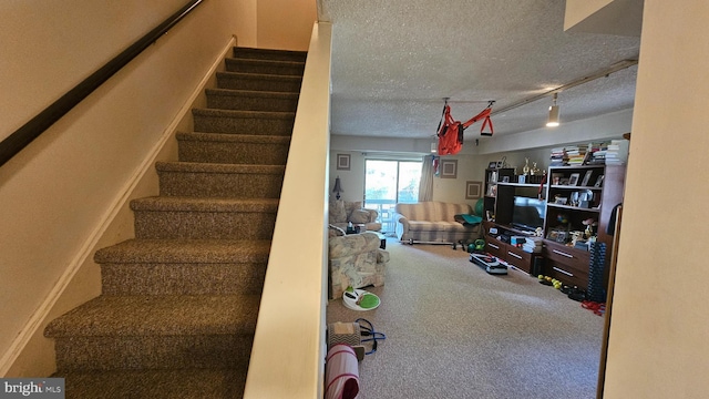 stairs with a textured ceiling