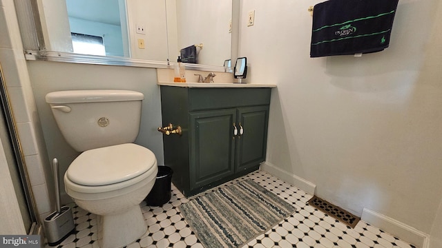 bathroom featuring toilet and vanity