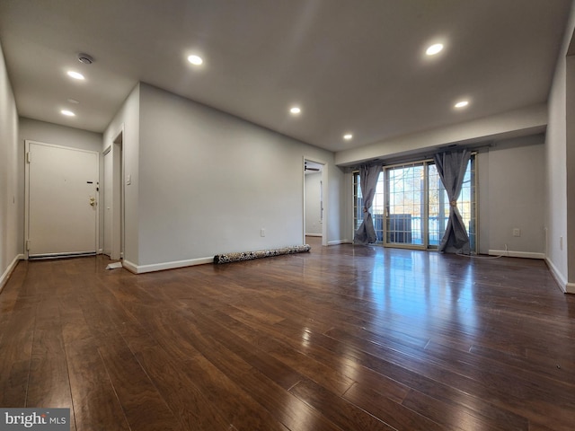 spare room featuring dark hardwood / wood-style flooring