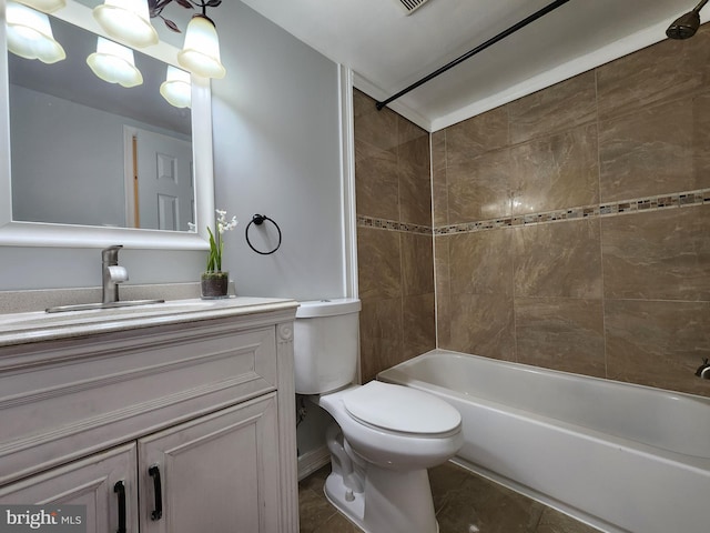 full bathroom with toilet, vanity, tile patterned floors, and tiled shower / bath