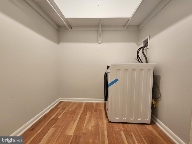 walk in closet with washer / dryer and light wood-type flooring