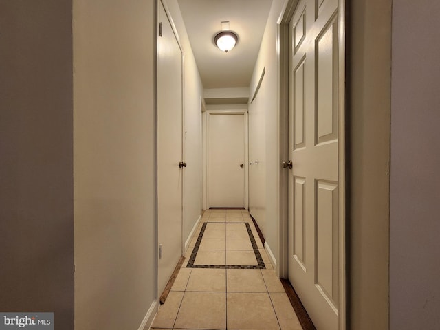 hall featuring light tile patterned floors