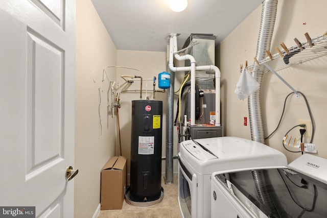 laundry area with washing machine and dryer, light tile patterned flooring, and electric water heater