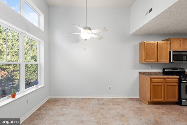 kitchen with appliances with stainless steel finishes and ceiling fan