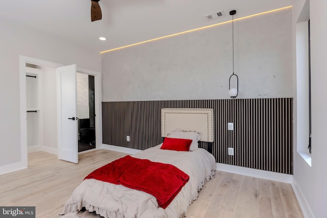 bedroom with ceiling fan and light hardwood / wood-style flooring