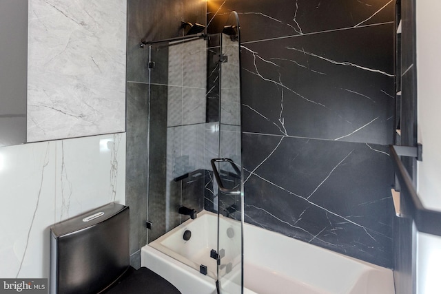 bathroom with toilet and tiled shower / bath combo