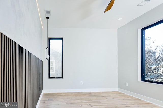 empty room featuring ceiling fan and light hardwood / wood-style flooring